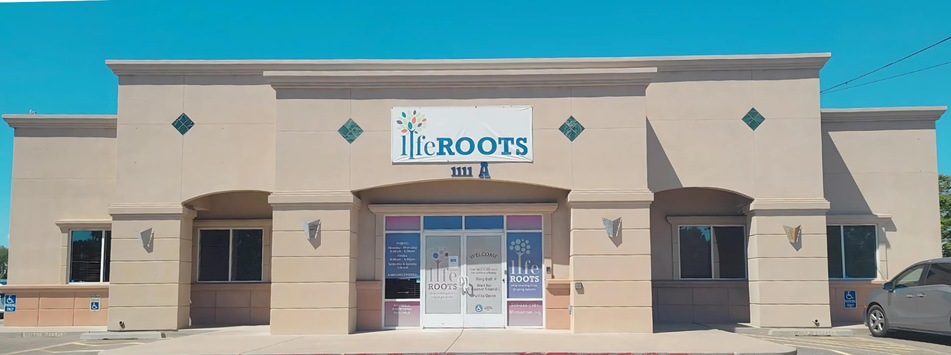 Front view of a building featuring a sign that reads "Liferoots" with the LifeROOTS logo above it.
