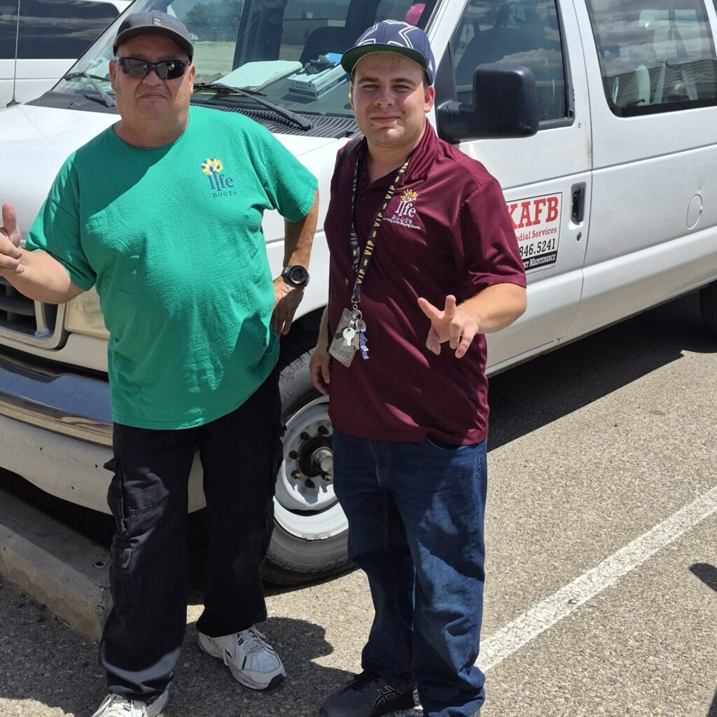 Two Liferoots, Inc. employees by their work van