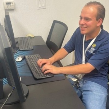 A Liferoots,.Inc. employee working in a computer lab